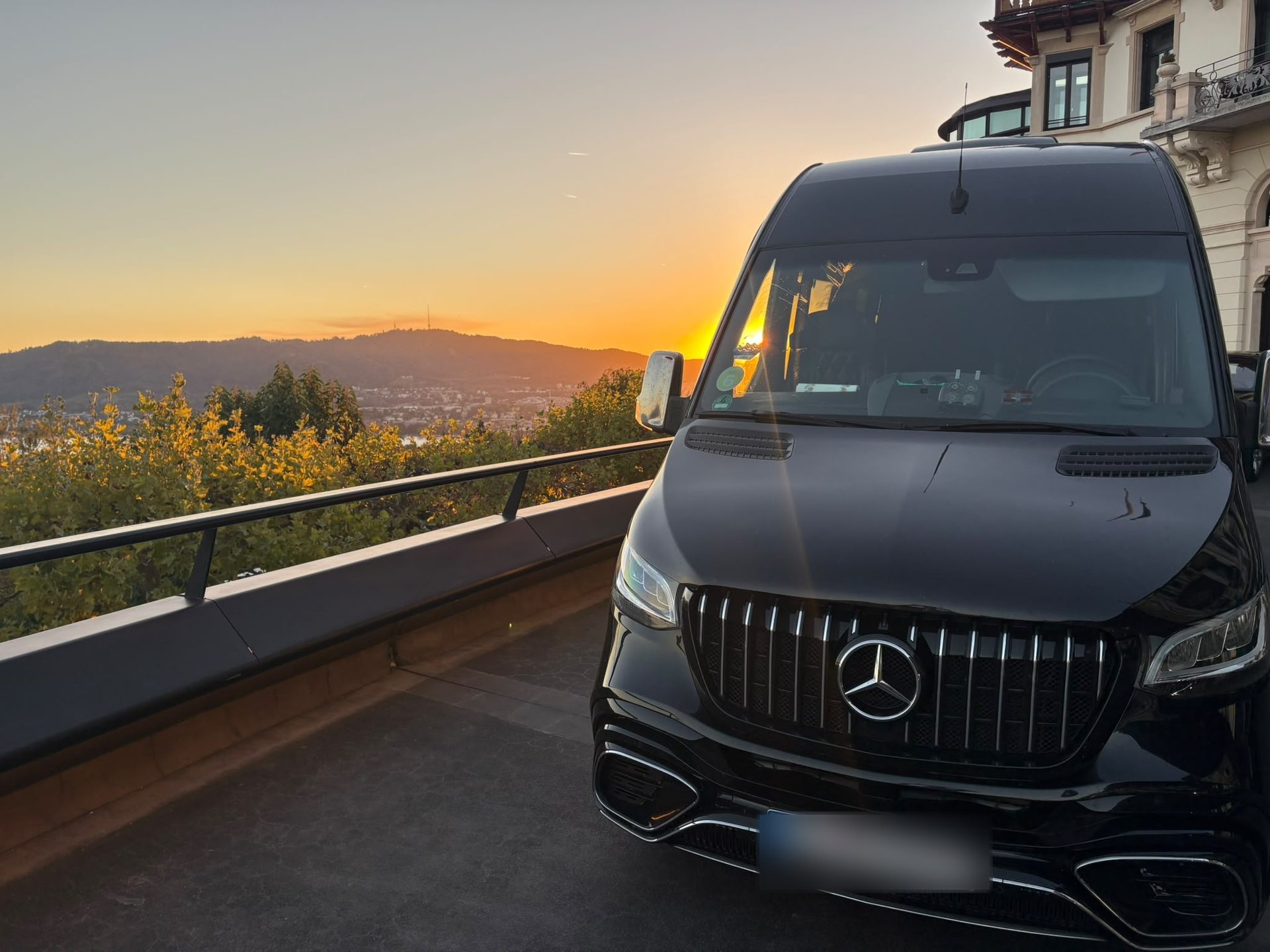 SprinterHire Mercedes Sprinter minibus above Zurich at sunset, hotel drop-off on the Dolder hill